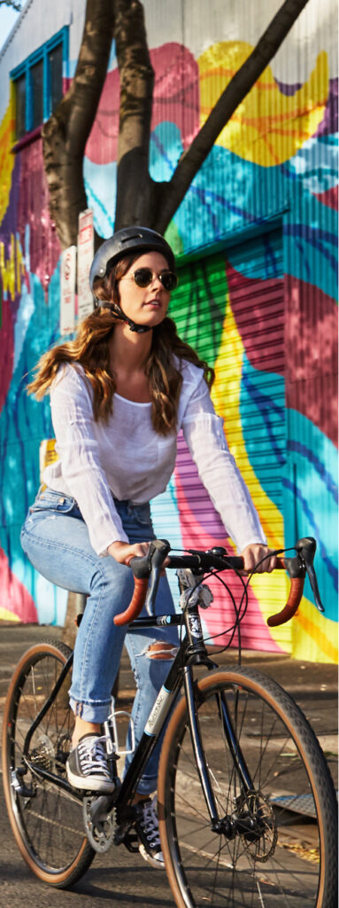 A woman rides her bike on a Sydney street.