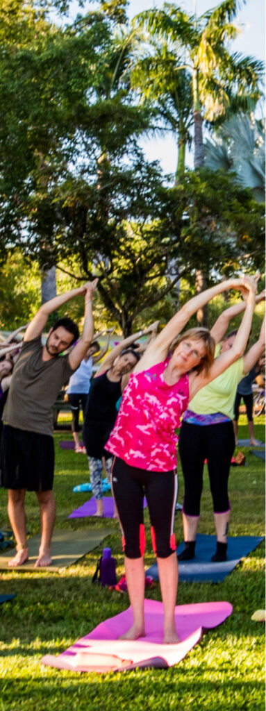 A group of people excercising in the park in Darwin.